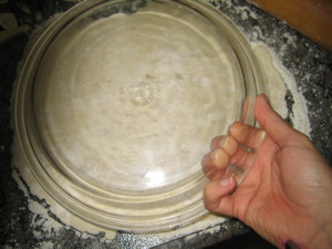 Measuring the dough against the pan